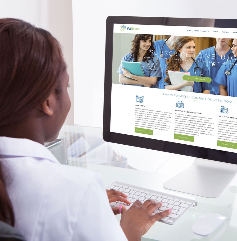 Woman on computer with VetBloom CE on screen