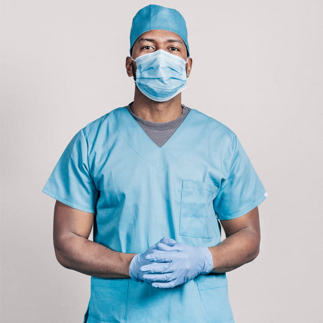 Male veterinarian wearing blue scrubs